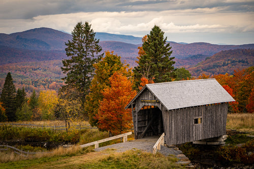 Peak foliage around the historical AM Foster Covered Bridge in Cabot, Vermont