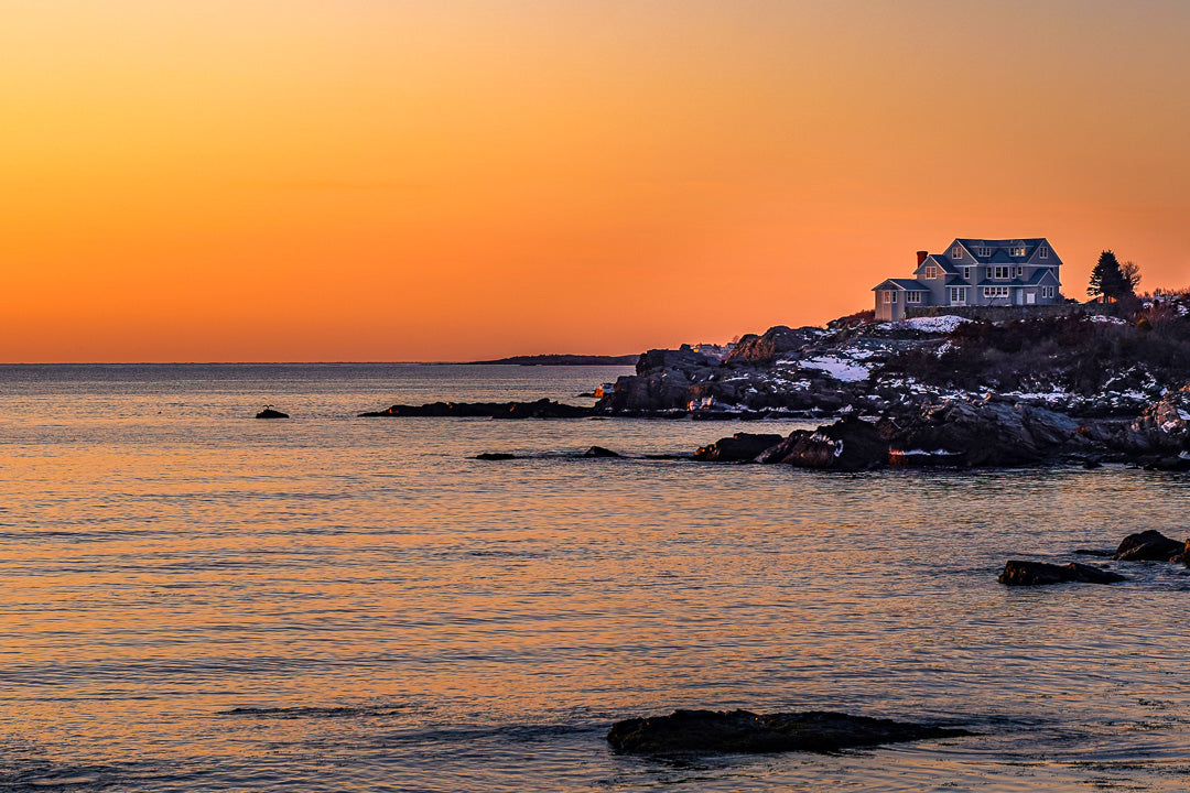 An intense sunrise on the rocky shores of Portland, Maine